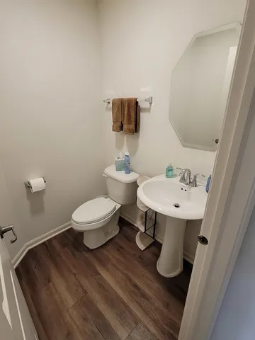 a bathroom with a sink toilet and mirror