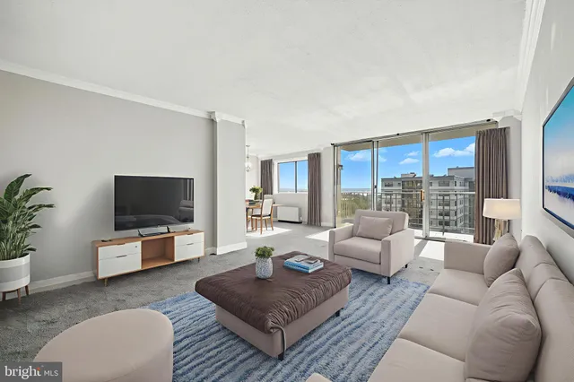 a living room with furniture flat screen tv and a large window