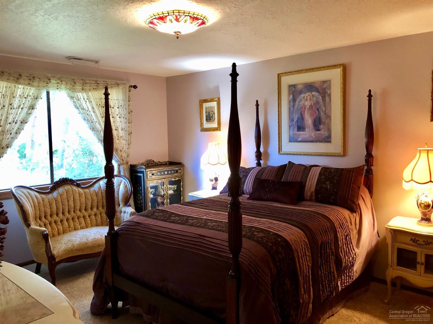 20416 Bullblock Road Bend, OR 97702 - Photo 16 of 23 a bedroom with a bed and a couch