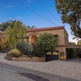 a front view of a house with a yard and a garage