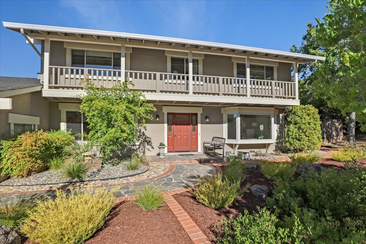 a front view of a house with a garden