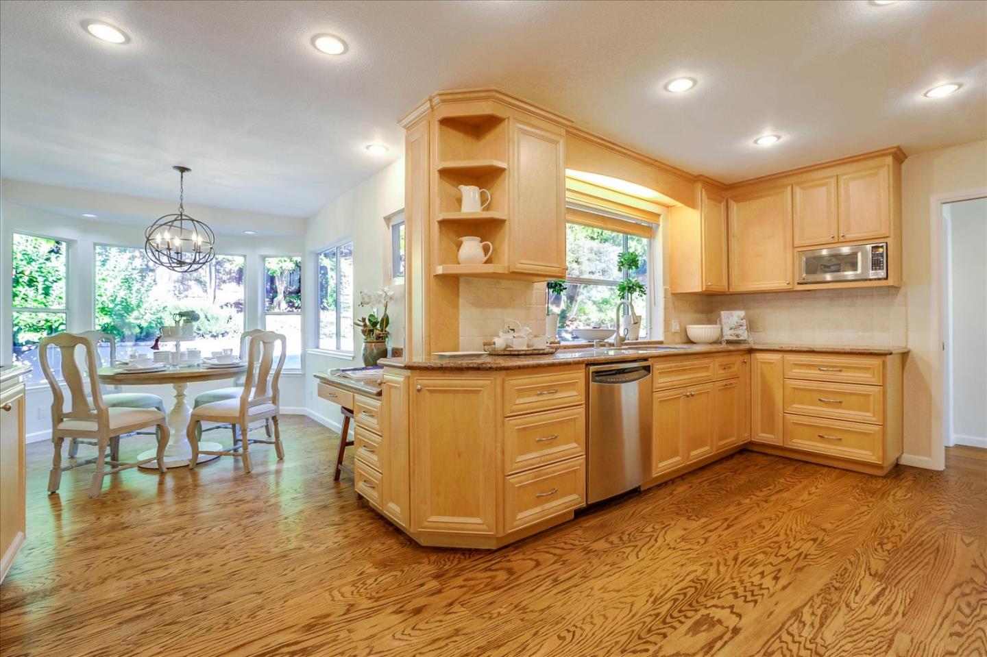1262 Chateau Drive San Jose, CA 95120 - Photo 13 of 57 an open kitchen with granite countertop a stove and white cabinets