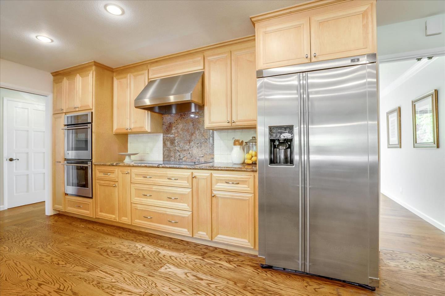 1262 Chateau Drive San Jose, CA 95120 - Photo 16 of 57 a kitchen with kitchen island granite countertop cabinets and refrigerator