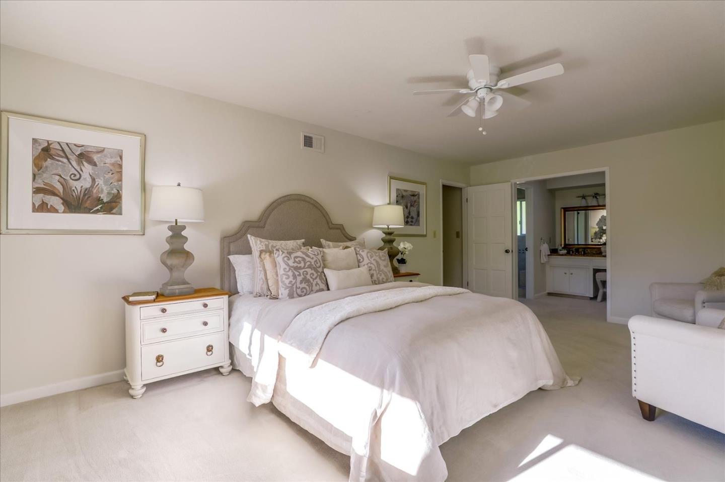 1262 Chateau Drive San Jose, CA 95120 - Photo 37 of 57 a spacious bedroom with a bed and a chandelier