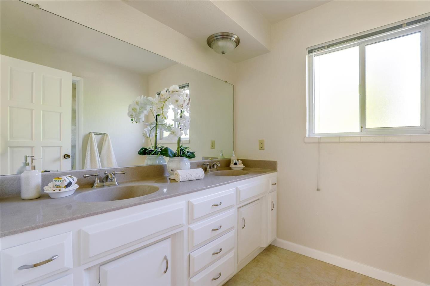1262 Chateau Drive San Jose, CA 95120 - Photo 40 of 57 a bathroom with a granite countertop sink mirror and window