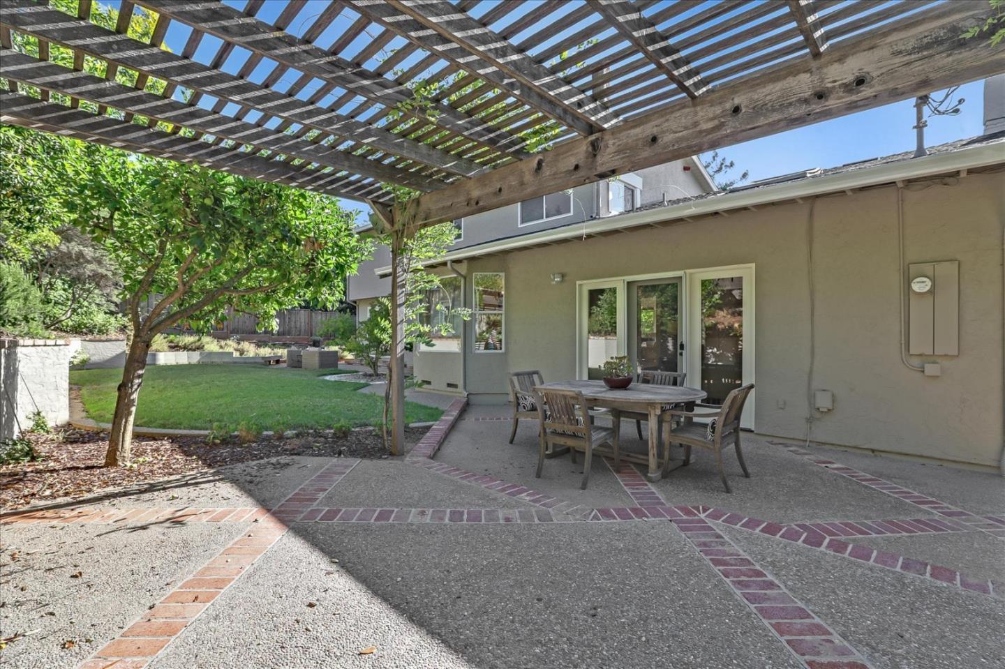 1262 Chateau Drive San Jose, CA 95120 - Photo 53 of 57 a view of a patio with table and chairs with wooden floor and fence