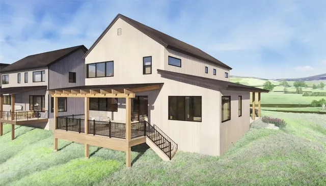 a view of a white house with a yard and table and chairs