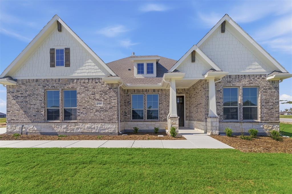 104 Snowy Owl Trail Rhome, TX 76078 - Photo 3 of 27 Traditional-style residence featuring a prominent brick and stone facade