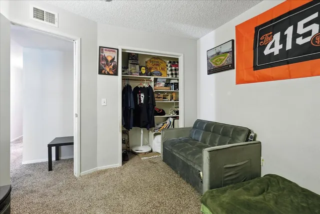 a living room with furniture and a walk in closet
