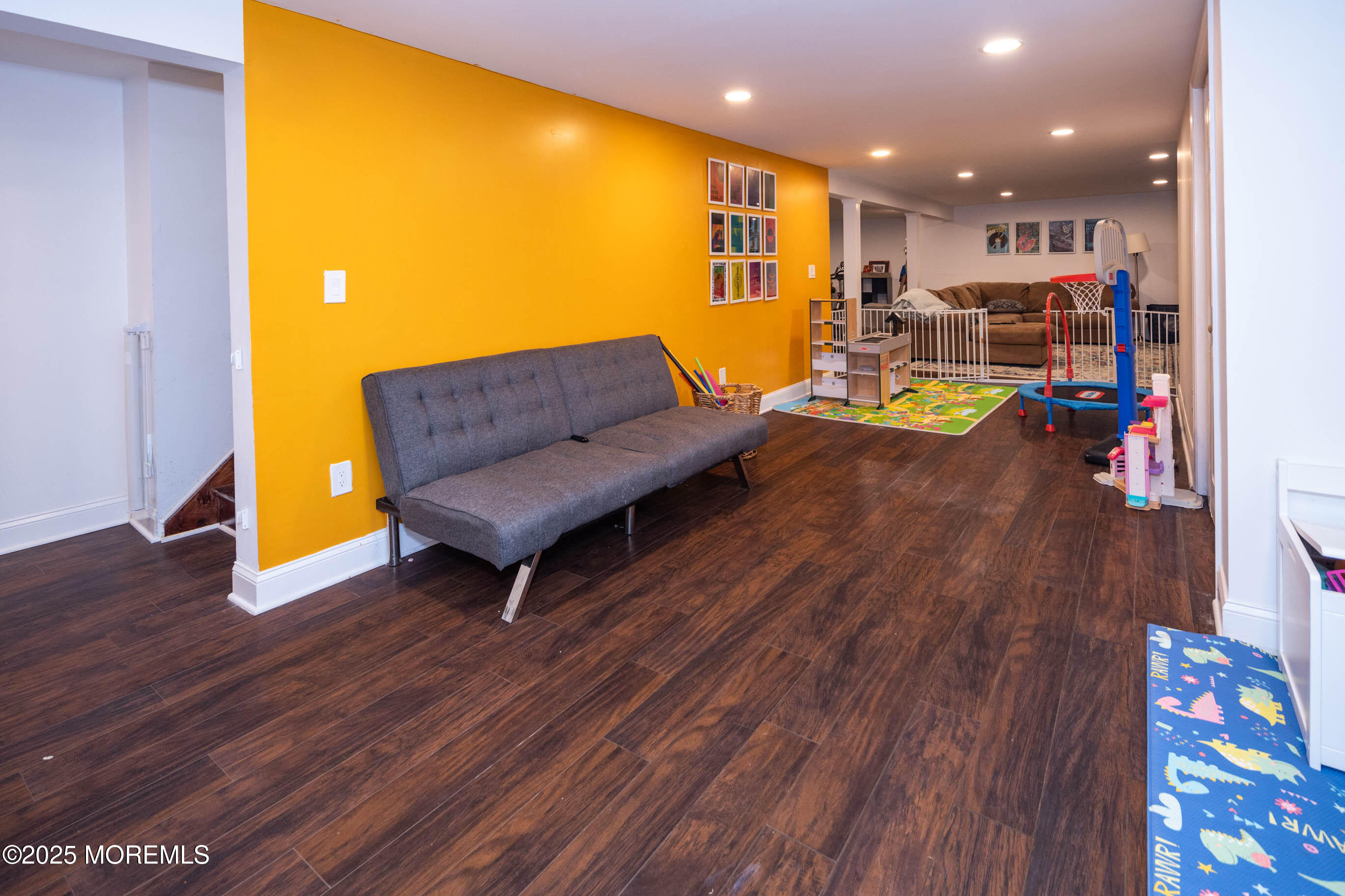 29 Telegraph Hill Road Holmdel, NJ 07733 - Photo 32 of 61 a living room with a couch and a dining table with wooden floor
