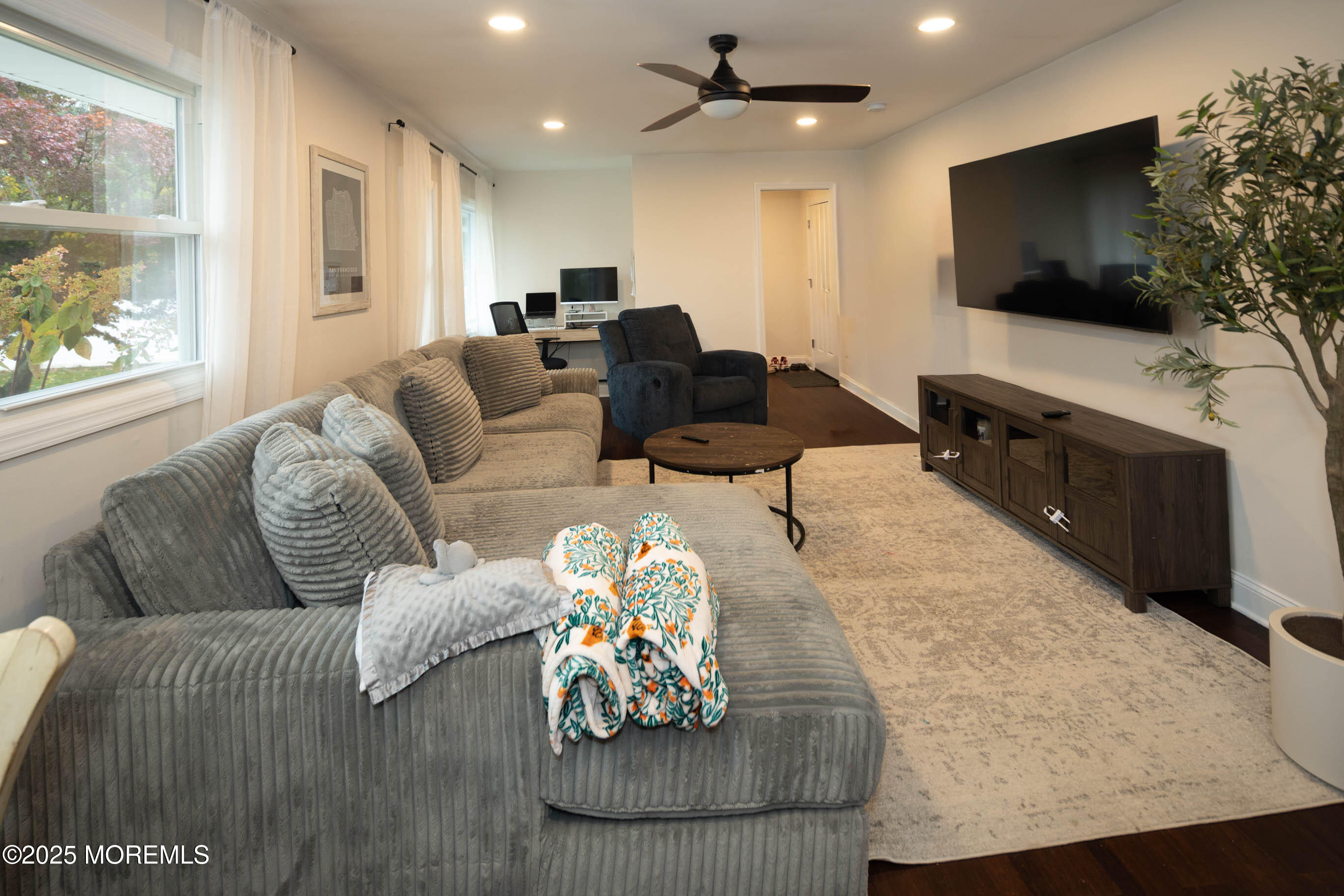 29 Telegraph Hill Road Holmdel, NJ 07733 - Photo 9 of 61 a living room with furniture and a flat screen tv