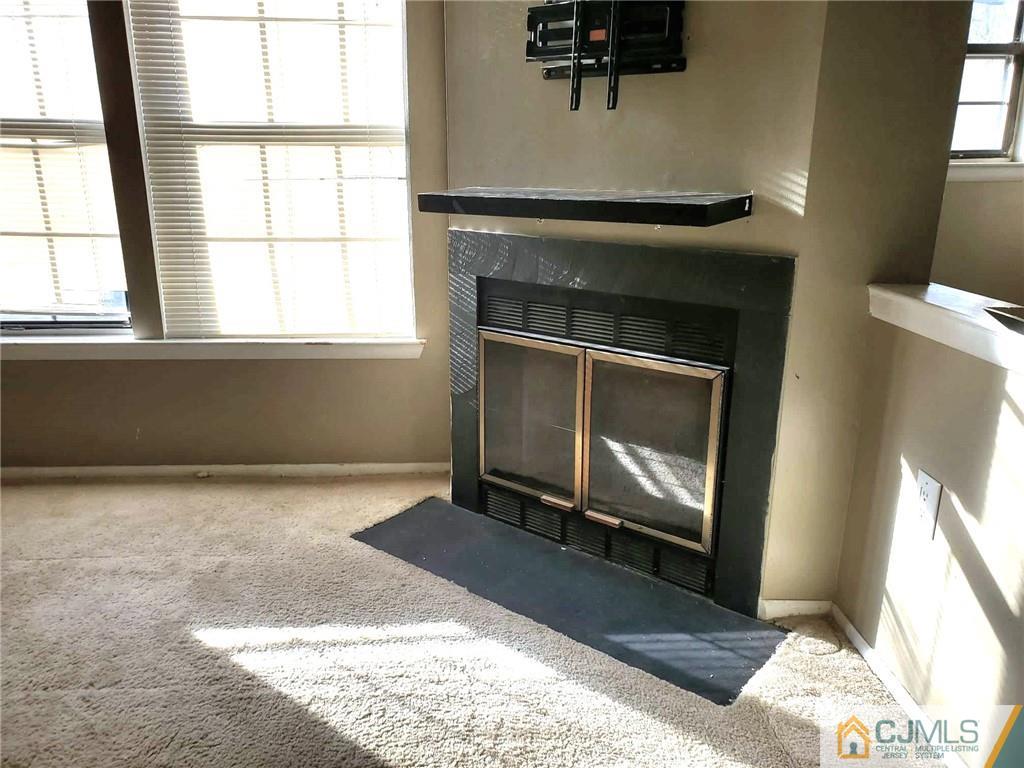 242 Azalea Circle Jackson, NJ 08527 - Photo 3 of 8 a view of an empty room with windows