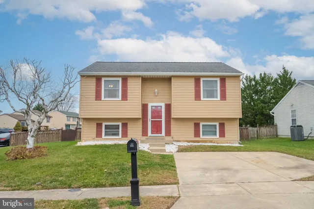 a living room with a couch and a chandelier