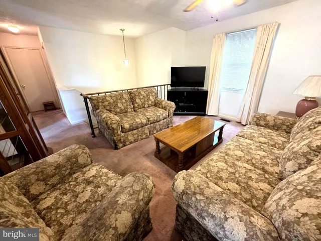 a living room with couches and flat screen tv
