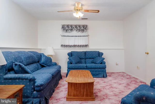 a living room with furniture and a rug
