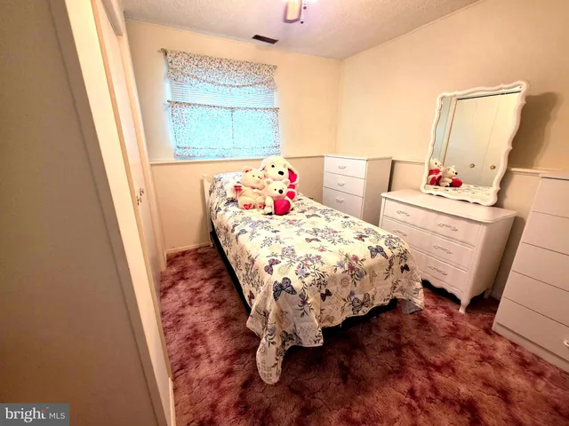 a bedroom with a bed and a mirror