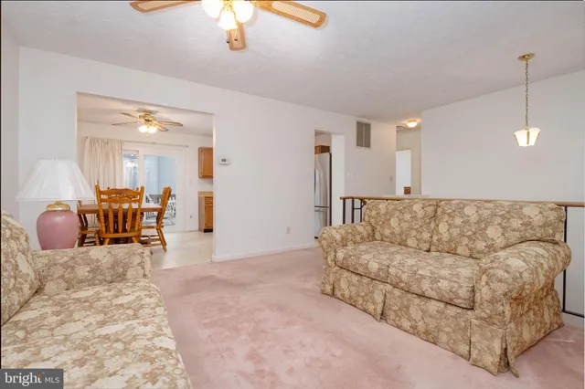 a view of a dining room with furniture and a chandelier