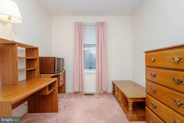 a room with a dresser and a mirror