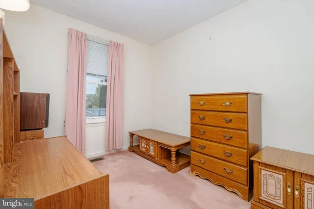 a bed sitting in a bedroom next to a bathroom