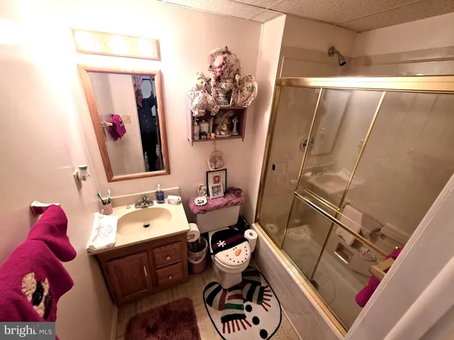a bathroom with a tub sink mirror and toilet