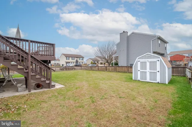 a view of a balcony with chairs and wooden floor