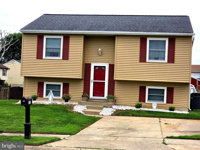 a view of a house with a yard and wooden fence