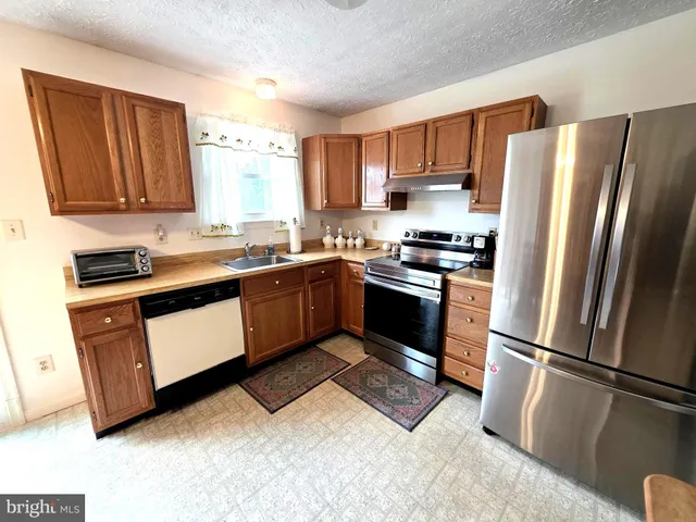 a kitchen with a sink stainless steel appliances and cabinets