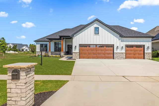 a front view of house with yard and green space