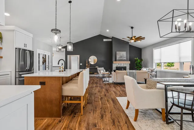 a living room with fireplace furniture and a wooden floor