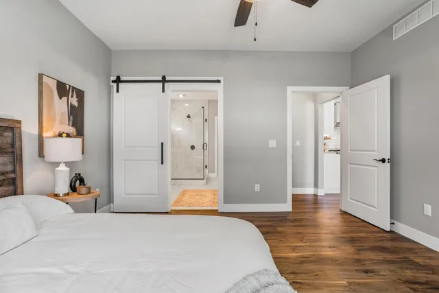 a spacious bedroom with a bed and a shower