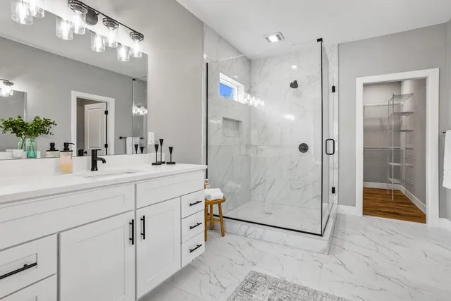 a bathroom with a shower sink and mirror