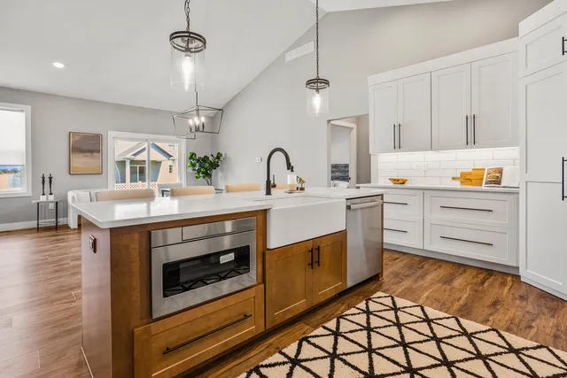 a kitchen with stainless steel appliances granite countertop a stove a sink and a refrigerator