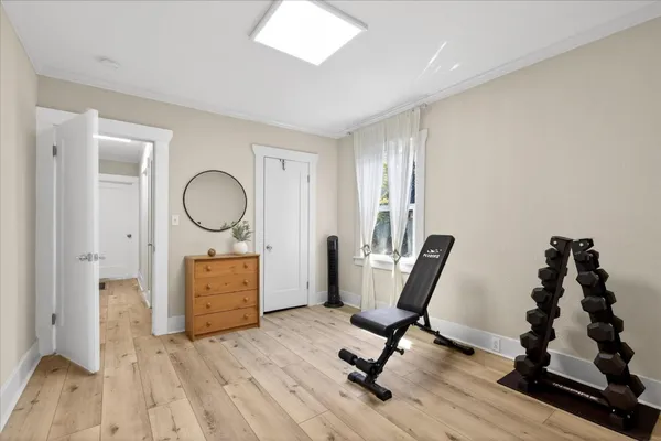 a view of dining room with wooden floor and windows