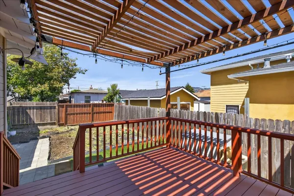 a view of a roof deck with wooden floor and fence