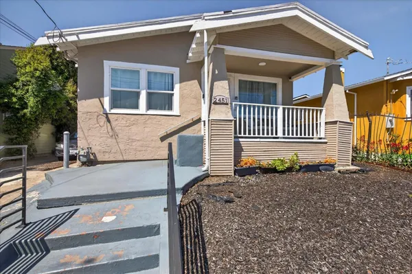 a view of a house with backyard and sitting area