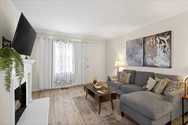 a living room with furniture fireplace and flat screen tv