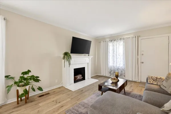 a living room with furniture a fireplace and a flat screen tv