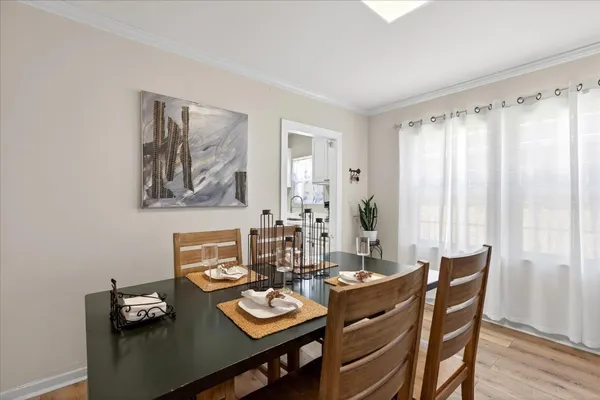 a view of a dining room with furniture window and wooden floor