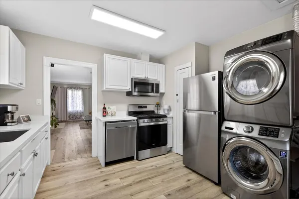 a kitchen with a refrigerator sink and wooden cabinets