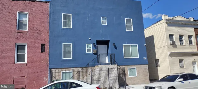 a front view of a building with parking space