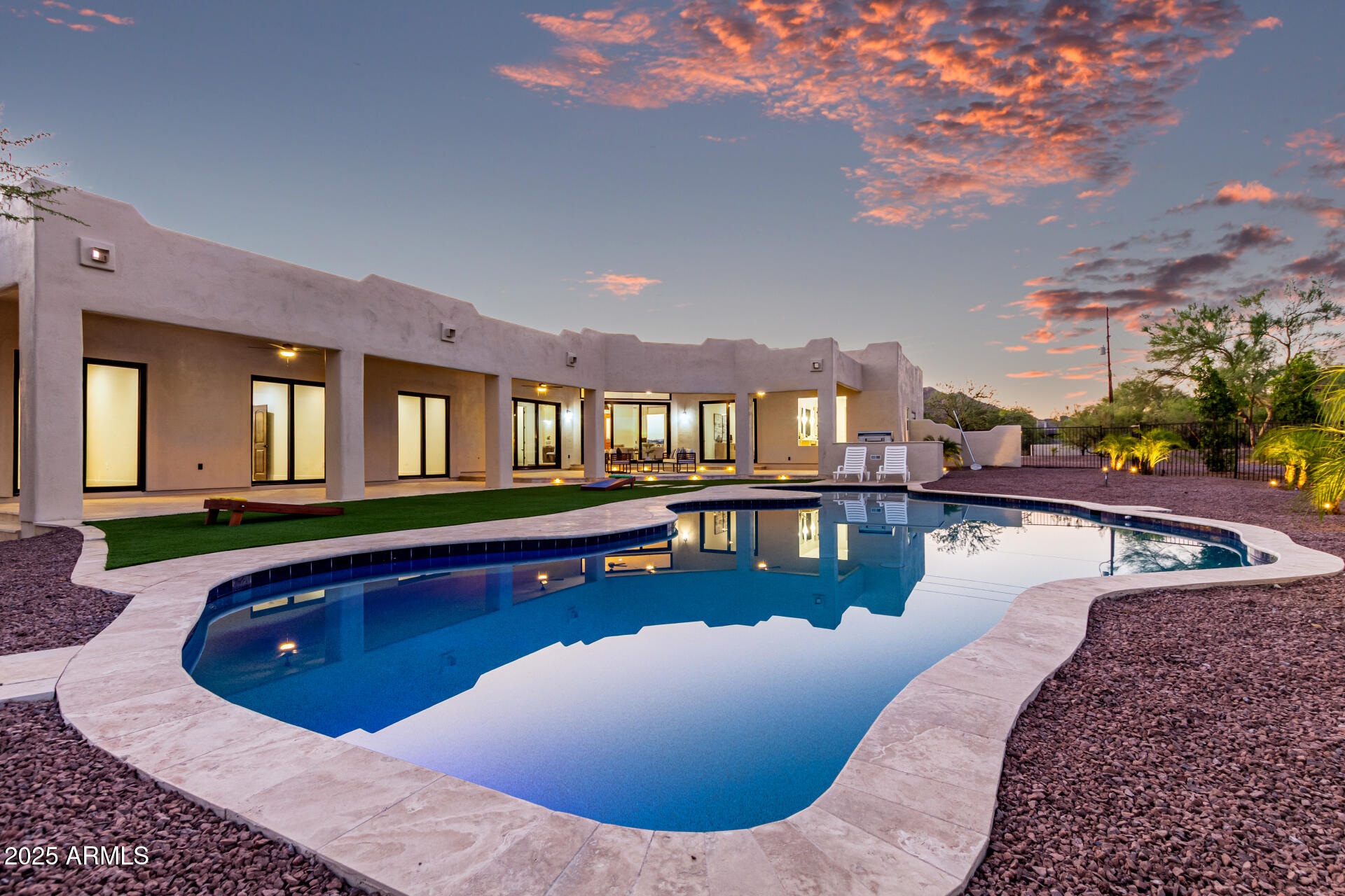 6735 East Dove Valley Road Cave Creek, AZ 85331 - Photo 46 of 58 a view of a swimming pool in front of a house