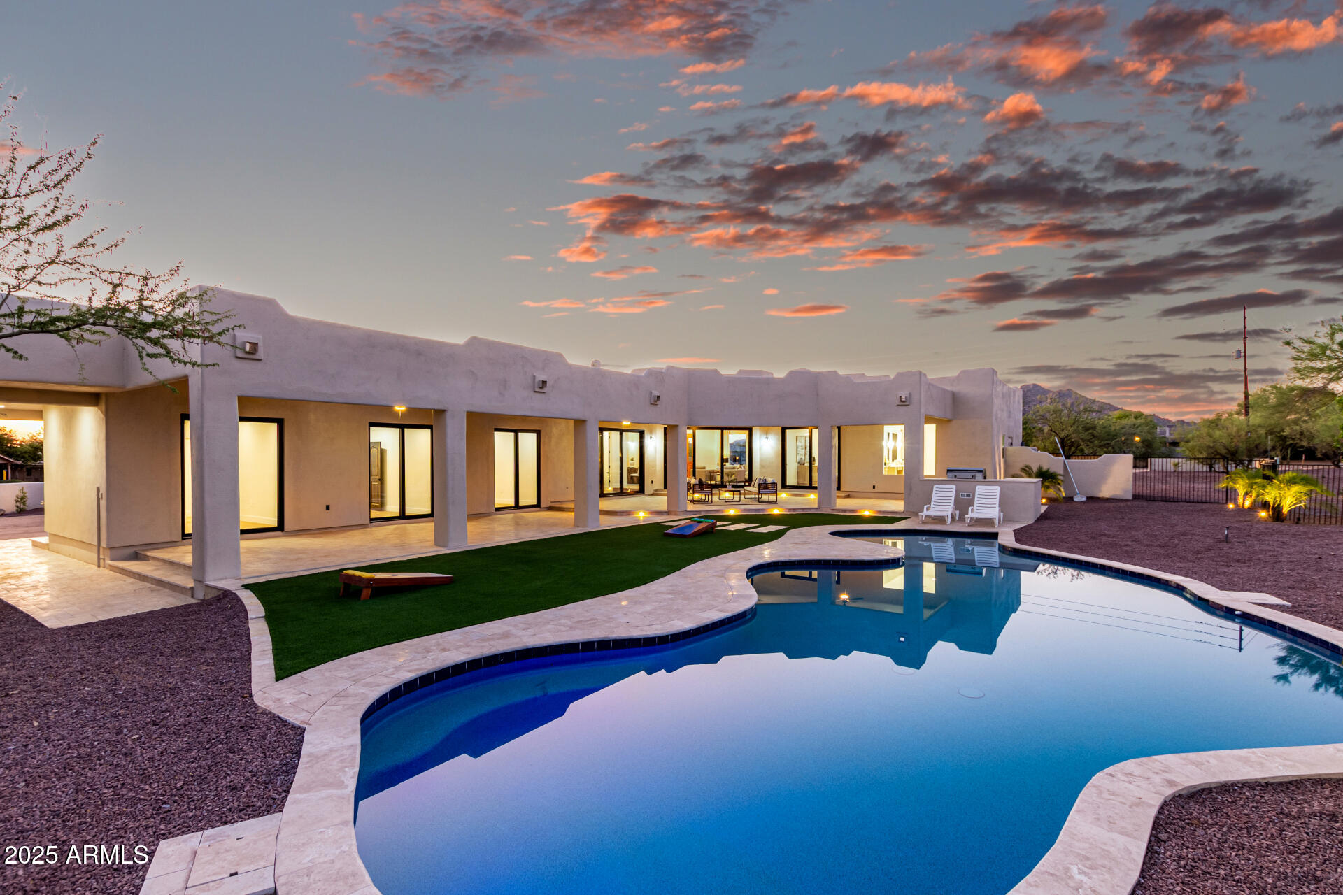 6735 East Dove Valley Road Cave Creek, AZ 85331 - Photo 47 of 58 a view of a house with swimming pool and sitting area