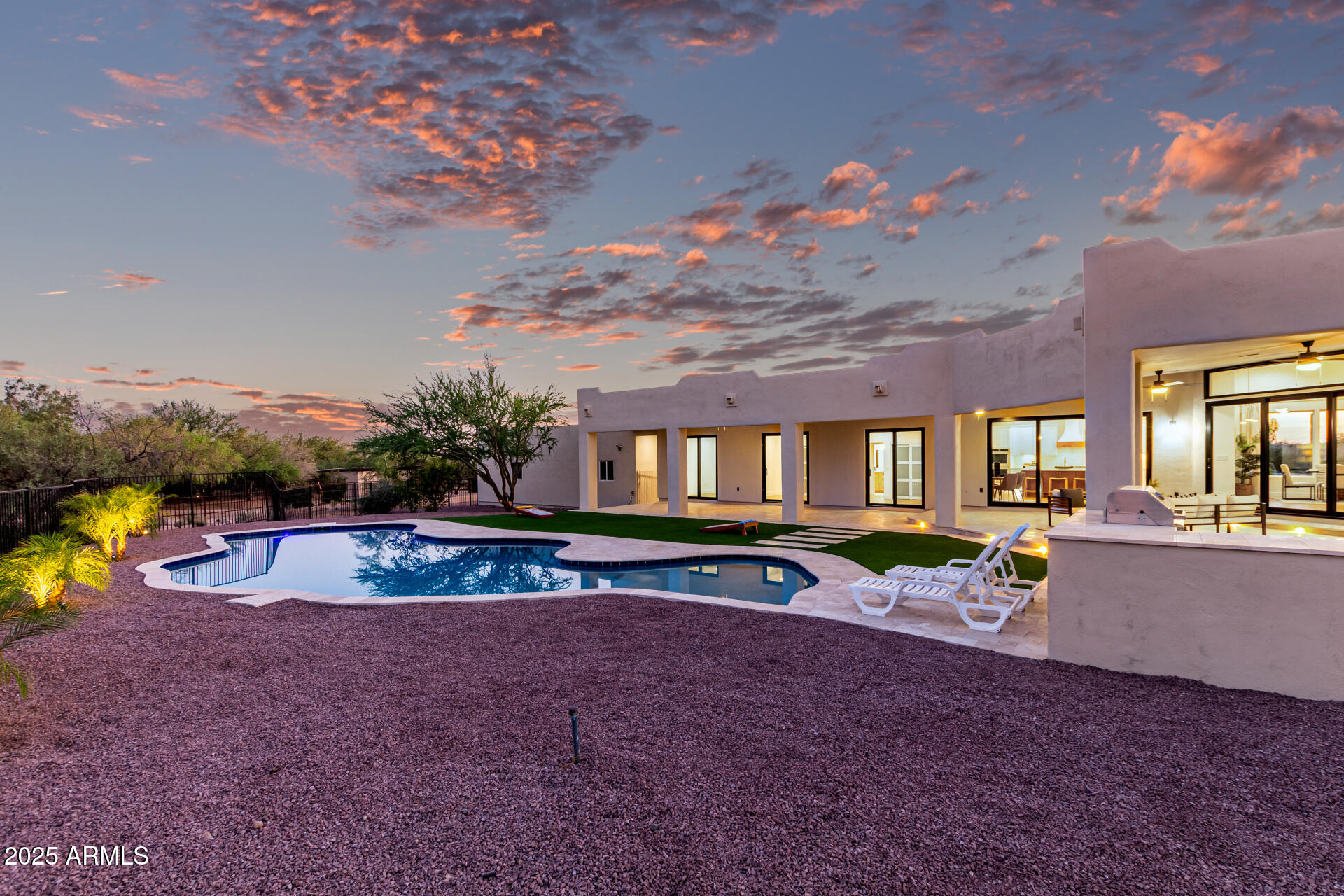 6735 East Dove Valley Road Cave Creek, AZ 85331 - Photo 48 of 58 a view of a house with pool and chairs