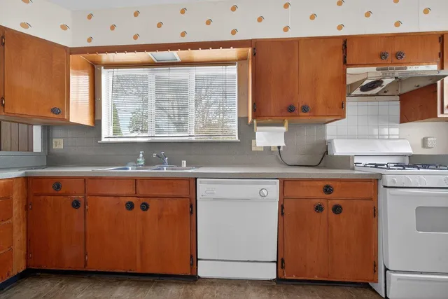 a kitchen with stainless steel appliances granite countertop a sink and a stove