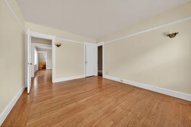 a view of an empty room and wooden floor