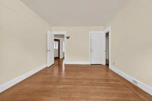 a view of an empty room and wooden floor