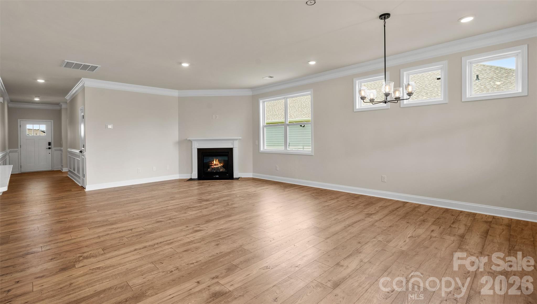 662 River Btm Road Fletcher, NC 28732 - Photo 12 of 31 an empty room with wooden floor and windows