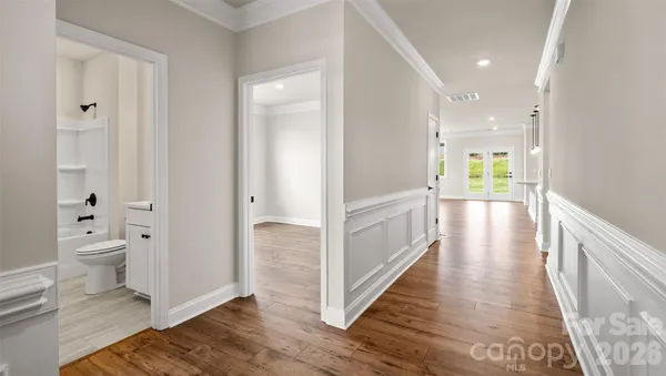a view of a hallway with wooden floor