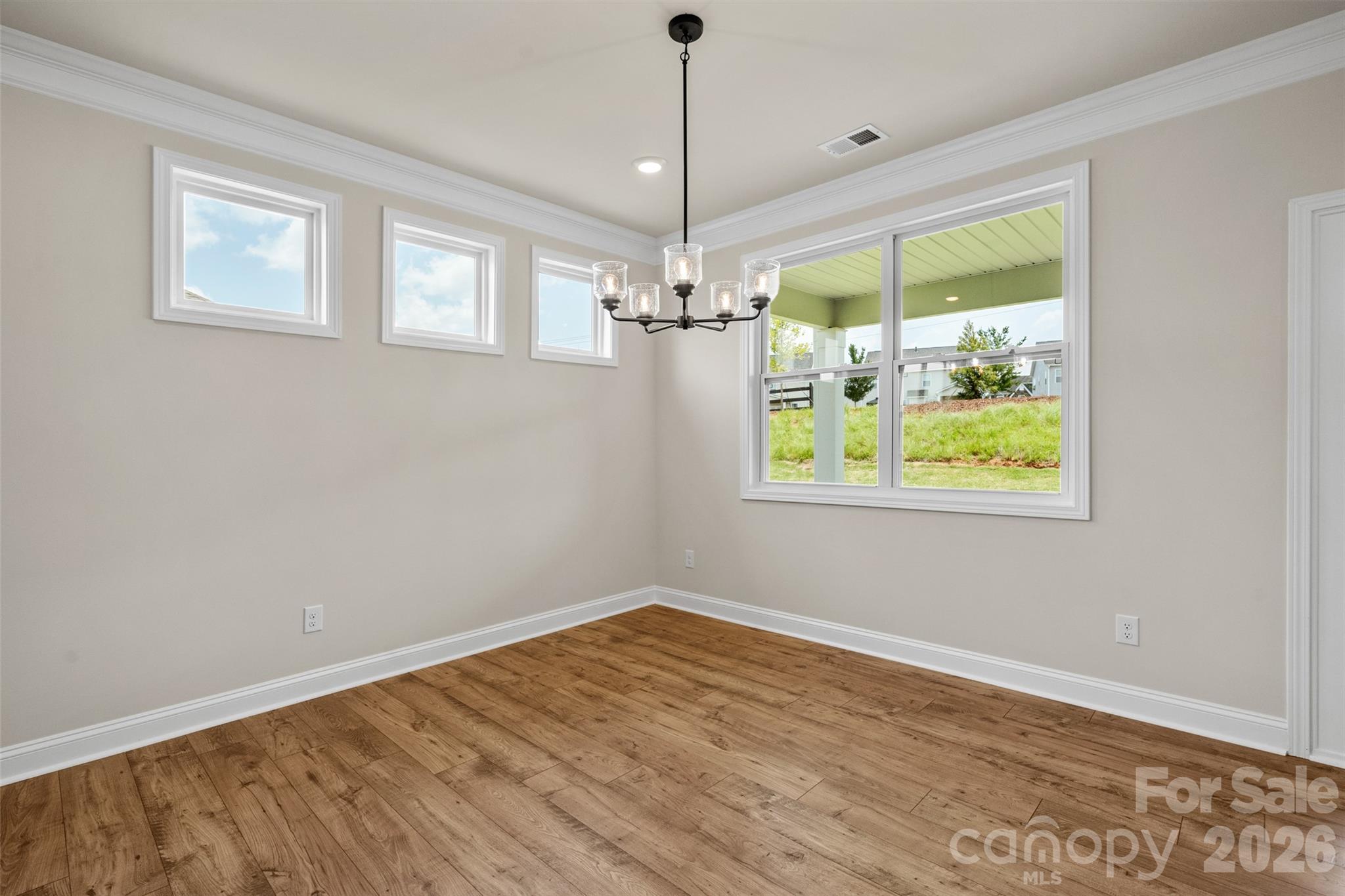 662 River Btm Road Fletcher, NC 28732 - Photo 14 of 31 a view of a room with wooden floor chandelier and windows