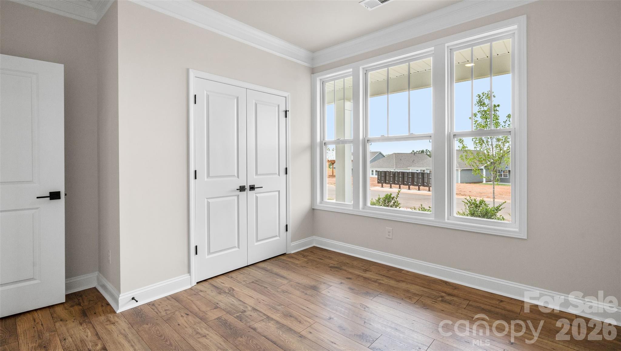 662 River Btm Road Fletcher, NC 28732 - Photo 15 of 31 a view of an empty room with wooden floor and a window